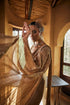 Beige gold tissue drape sari set with cape sleeve blouse and pre daped sari